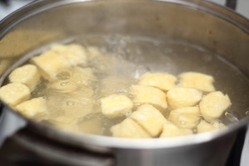 Gnocchi being prepared. Boiling. Dough dumplings with cheese.