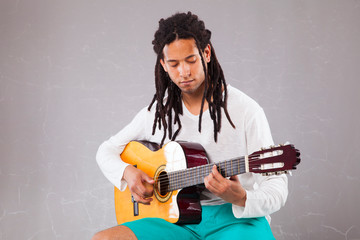 rastafari man holding a classic guitar
