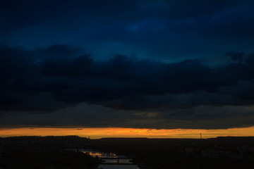 Fototapeta premium Sunset or sunrise over a river with a bridge