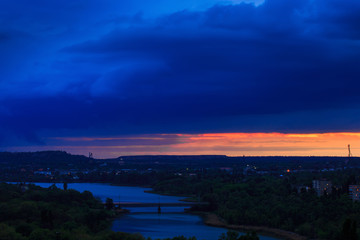 Obraz premium Sunset or sunrise over a river in hilly terrain