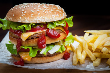 hamburger with French fries on the Board close up