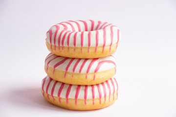 Group of colourful doughnuts lies on pink background. Horizontal photography. Theme of delivery from Fast Food Restaurant