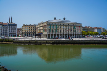 The city of Bayonne in France with buildings in the Nive River