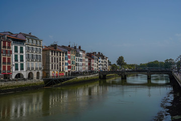 Fototapeta na wymiar The city of Bayonne in France with buildings in the Nive River