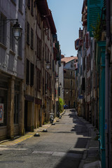 Fototapeta na wymiar Street of Bayonne in France with buildings in the Nive River