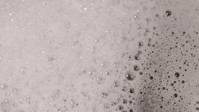 soap foam bubbles on the water surface