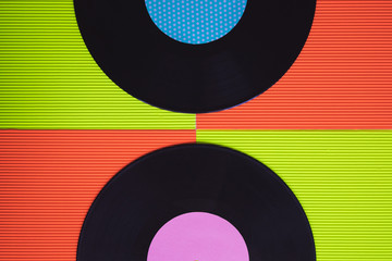 Black vinyl arranged on a red and green background seen from above