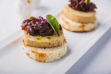 Homemade duck liver pate with bruschetta, greens and red onion jam