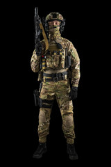 Soldier holding assault rifle. Uniform conforms to special services of the Russian Federation. Shot in studio. Isolated with clipping path on black background