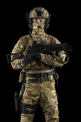 Soldier holding assault rifle. Uniform conforms to special services of the Russian Federation. Shot in studio. Isolated with clipping path on black background