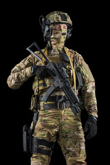 Soldier holding assault rifle. Uniform conforms to special services of the Russian Federation. Shot in studio. Isolated with clipping path on black background