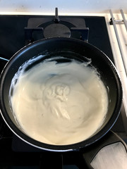 Making and Cooking Cream in Pot For Pasteis de Nata or Belem Tart. Portuguese Custard made with Egg, Cinnamon, Sugar and Flour.