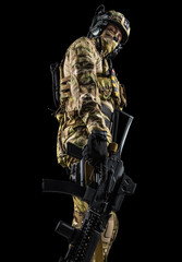 Soldier holding assault rifle. Uniform conforms to special services of the Russian Federation. Shot...