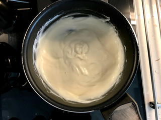 Making and Cooking Cream in Pot For Pasteis de Nata or Belem Tart. Portuguese Custard made with Egg, Cinnamon, Sugar and Flour.