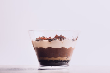 Family Pot of Irresistible Layered Billionaires Dessert made from mousse, Belgian chocolate sauce, digestive biscuit crumb and chocolate sponge. Finished with choco chunks and decorated with icing