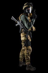 Soldier holding assault rifle. Uniform conforms to special services of the Russian Federation. Shot in studio. Isolated with clipping path on black background