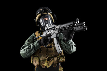Soldier holding assault rifle. Uniform conforms to special services of the Russian Federation. Shot in studio. Isolated with clipping path on black background