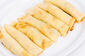Delicious pancakes rolls filled with meat and cheese. 
