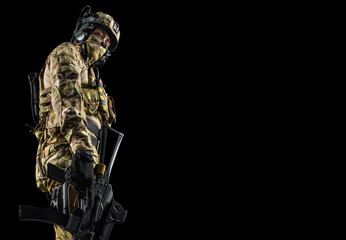 Soldier holding assault rifle. Uniform conforms to special services of the Russian Federation. Shot...