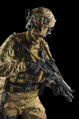 Soldier holding assault rifle. Uniform conforms to special services of the Russian Federation. Shot in studio. Isolated with clipping path on black background