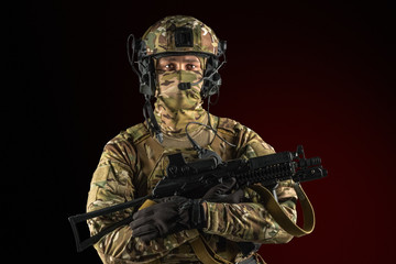 Soldier holding assault rifle. Uniform conforms to special services of the Russian Federation. Shot in studio. Isolated with clipping path on black background