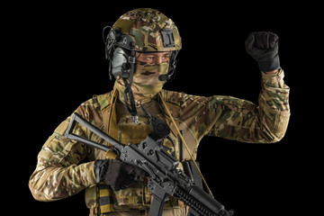 Soldier holding assault rifle. Uniform conforms to special services of the Russian Federation. Shot in studio. Isolated with clipping path on black background