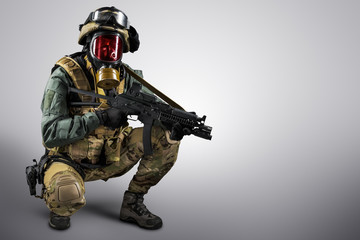 Soldier holding assault rifle. Uniform conforms to special services of the Russian Federation. Shot in studio. Isolated with clipping path on grey background