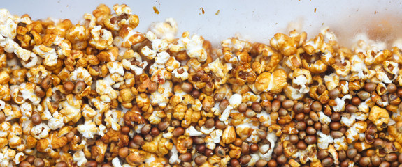 Sweet popcorn behind glass as an abstract background.