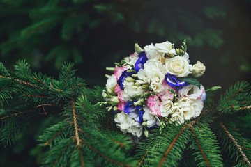 Obraz na płótnie Canvas Beautiful colorful wedding bouquet on a green background. Copy space for text. Close-up. Soft focus. 