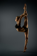 Sport Woman Stretching Twine, Beautiful Gymnast Girl Standing on one Leg and Stretch Gymnastics...