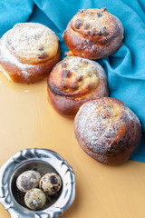 Open buns with cottage cheese (cheesecake) lie on a black graphite table. Parchment. Сloseup. Country photo.
