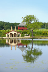 Fototapeta premium Traditional buildings on the edge of a beautiful lake with reflections in the water, located near Kvaerndrup, in the south of the island of Funen, Denmark.