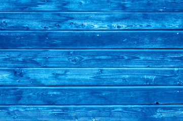 wooden boards background. aged burned black and blue wooden planks. toned classic blue color trend 2020 year