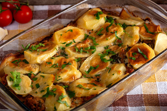 Homemade moussaka with meat, potatoes and herbs