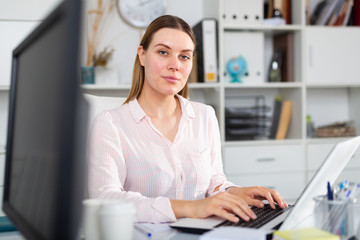 Young woman working at office alone