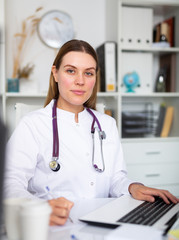 Doctor working effectively in her office