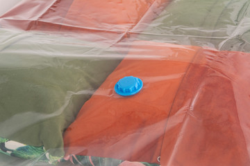 Space saver saving seal bag sucking air vacuum clothing storage compressed package.