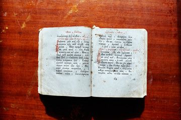 Old book with ancient text on a wooden table