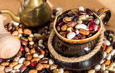 mix of dried multi-colored kidney beans in clay cup, super food, still life of black bean ,red...