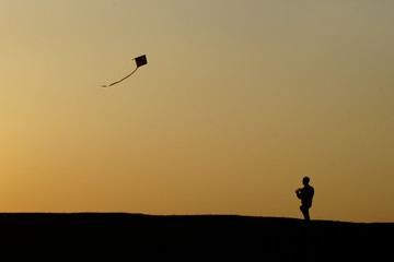 flying kites on sunset