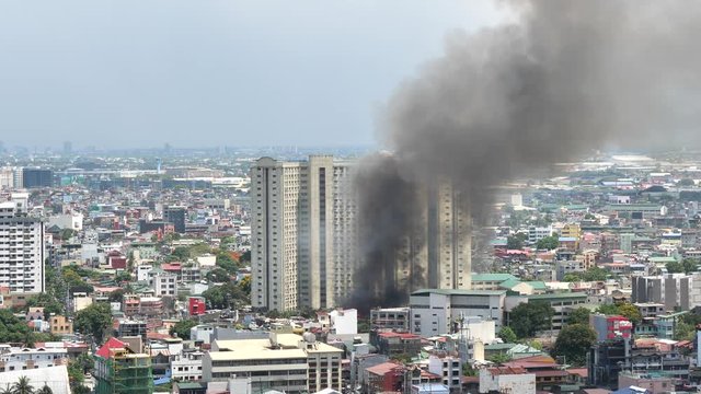 Fire hits squatter area in Pasay - Philippines May 17, 2020. Video is taken from one of high rise condo building in Makati city of Manila - Philippines