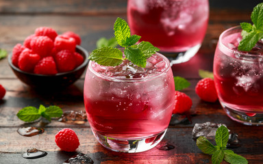 Refreshing Strawberry cocktail with ice and mint on wooden table