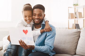 Pretty afro girl congratulating dad with father's day