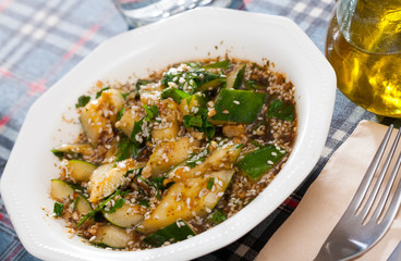 Plate with salad broken cucumbers with sesame seeds