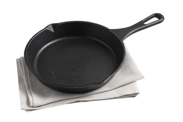 Empty iron pan and napkin on white background