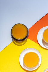  orange juice from above on colored backgrounds.