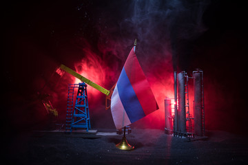 Business dialogue, oil agreement concept: National flags with Oil pump and oil refining factory at...