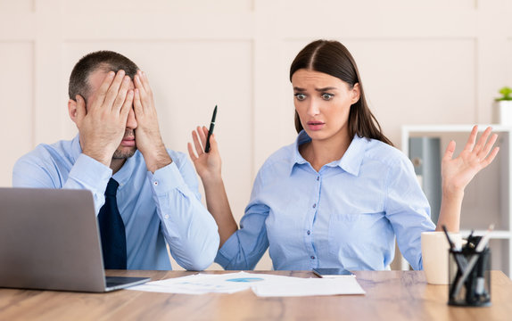 Businessman Covering Eyes Unable To Train Incompetent Girl In Office