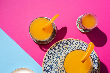  orange juice from above on colored backgrounds.
