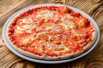 Italian pizza on a thin dough with a variety of stuffed. Mixed media